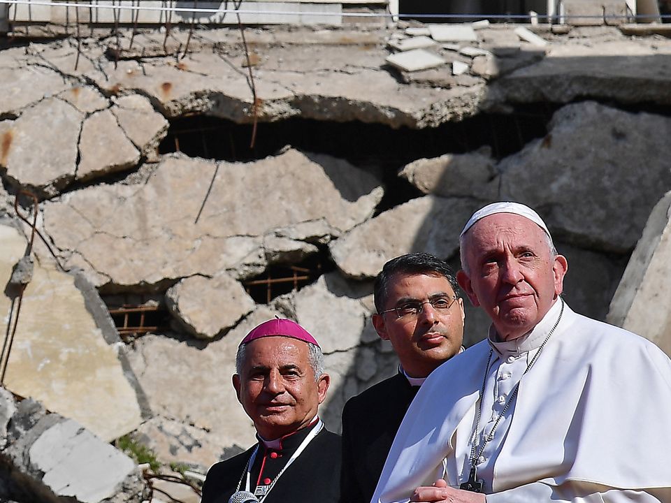 Passengers wait ⁣in a crowded airport terminal amidst flight cancellations.