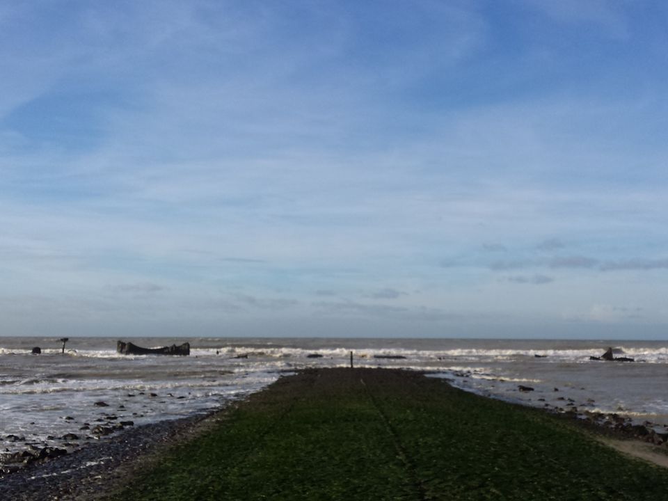The partially‌ exposed wreck⁣ of the Prince George on the beach at Camperduin.