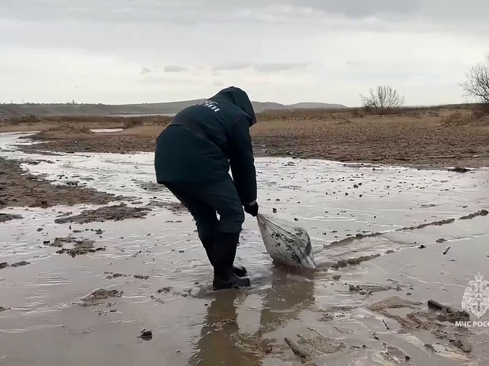 Passengers wait at a snow-covered airport terminal.