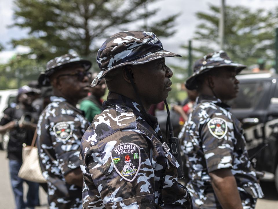 Passengers wait in a‍ crowded airport terminal amidst flight cancellations.