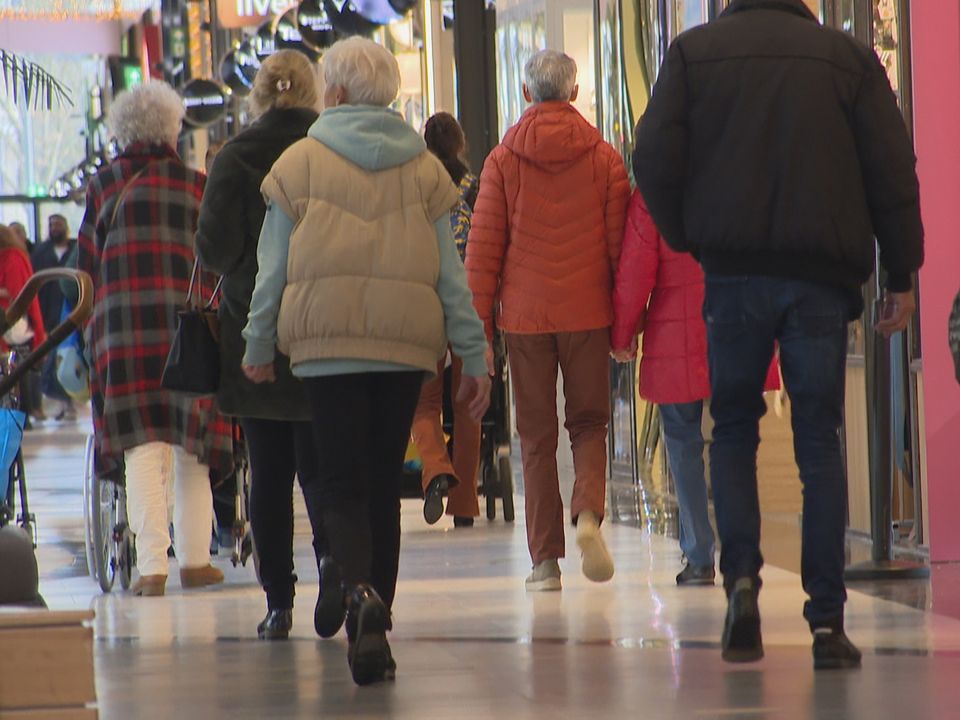 Passengers wait at a snow-covered airport terminal.