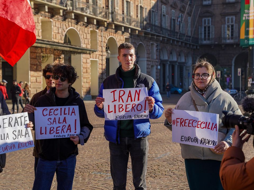 A vibrant, multicolored arc stretches across a blue sky.
