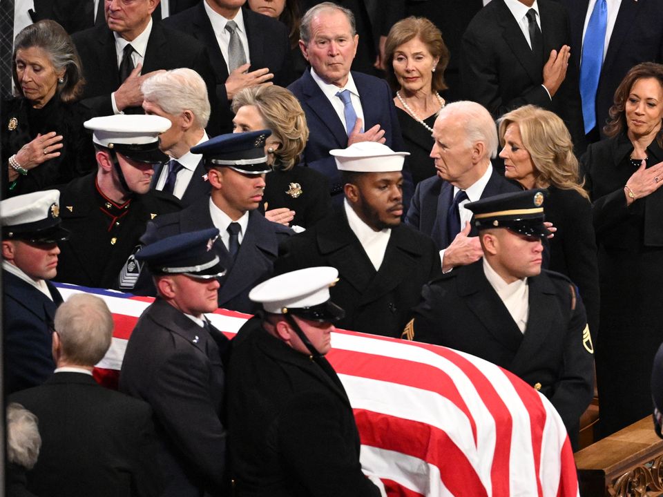 A vibrant fire rainbow arches across a blue sky.