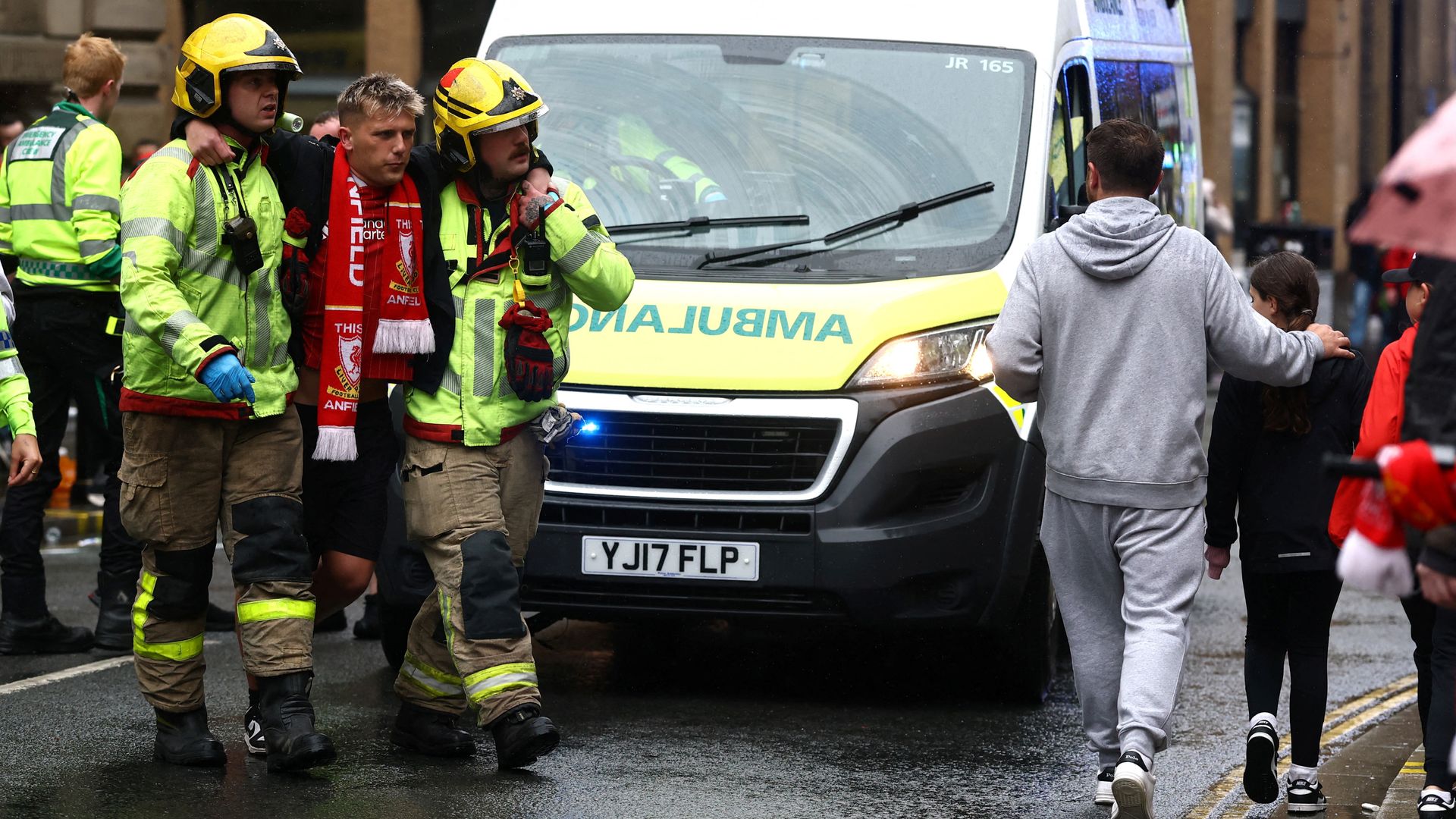 A wounded fan is helped